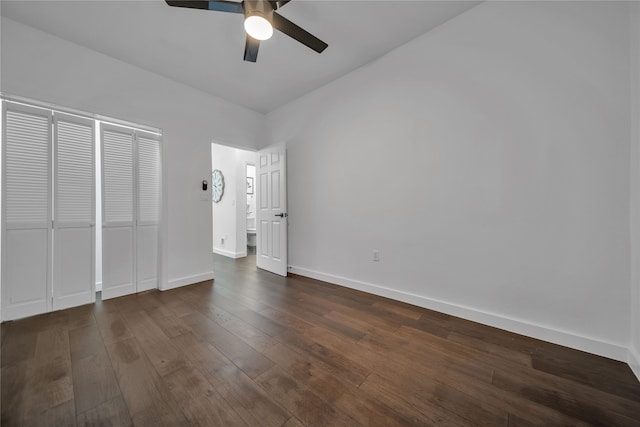 unfurnished bedroom with ceiling fan and dark wood-type flooring