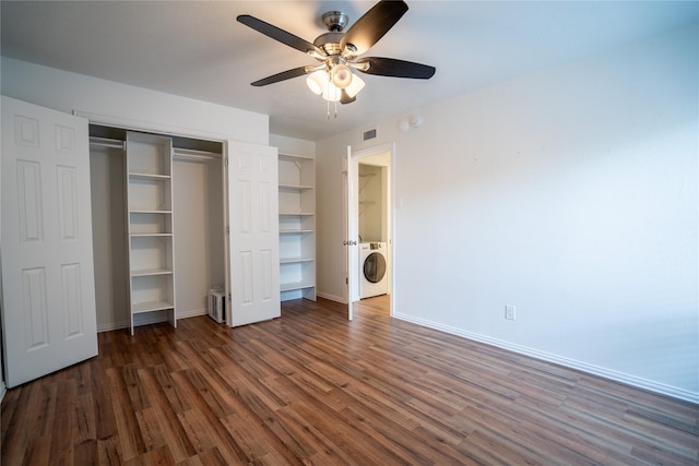 unfurnished bedroom featuring ceiling fan, washer / dryer, and dark wood-type flooring