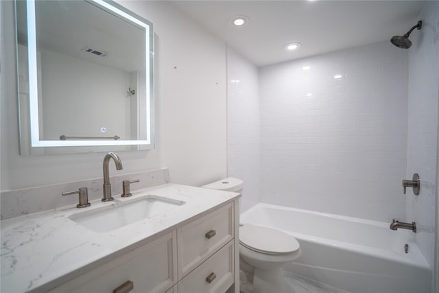 full bathroom featuring vanity, toilet, and tiled shower / bath