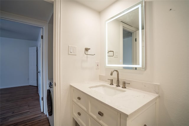 bathroom with vanity, wood-type flooring, and washer / clothes dryer