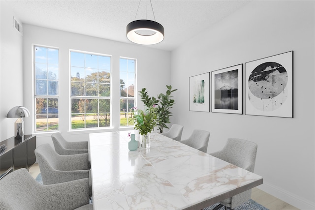 dining room with a textured ceiling