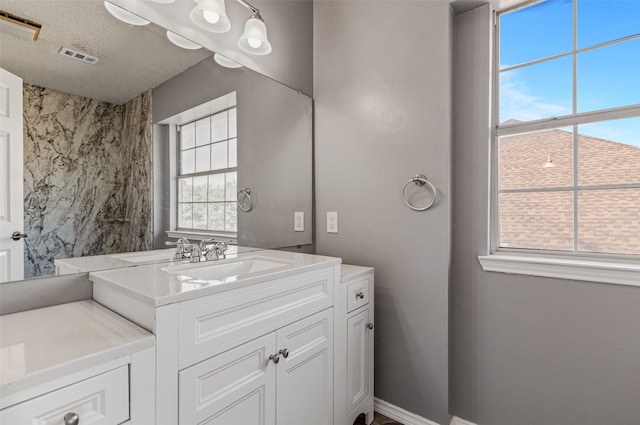 bathroom with vanity and a textured ceiling