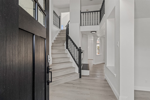 entrance foyer featuring a textured ceiling and light hardwood / wood-style flooring