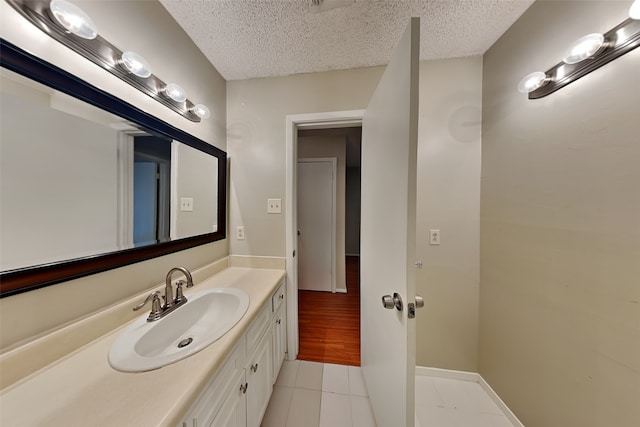 bathroom featuring vanity, a textured ceiling, and hardwood / wood-style flooring