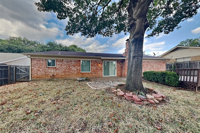 rear view of house featuring a lawn