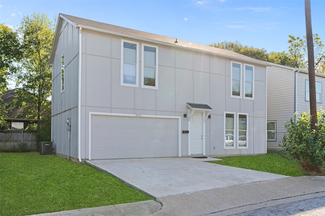 view of front of house with central AC, a front lawn, and a garage