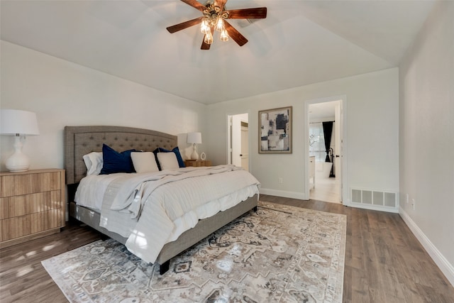 bedroom featuring ceiling fan, dark wood-type flooring, and lofted ceiling