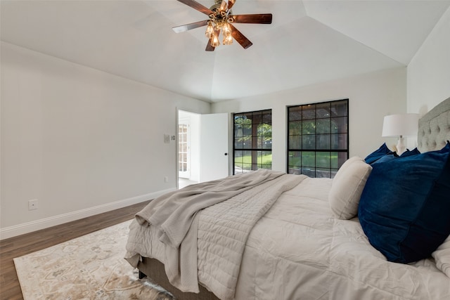 bedroom featuring dark hardwood / wood-style floors, ceiling fan, and lofted ceiling