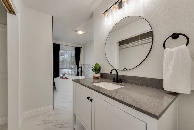 bathroom with a bath and vanity