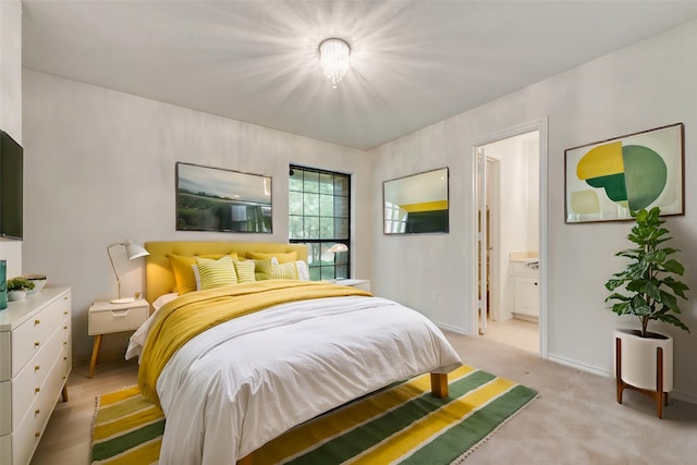 carpeted bedroom featuring ensuite bathroom