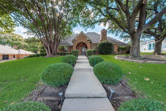 ranch-style house featuring a front yard