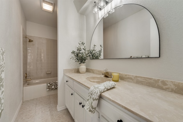 bathroom featuring tile patterned floors, vanity, and tiled shower / bath