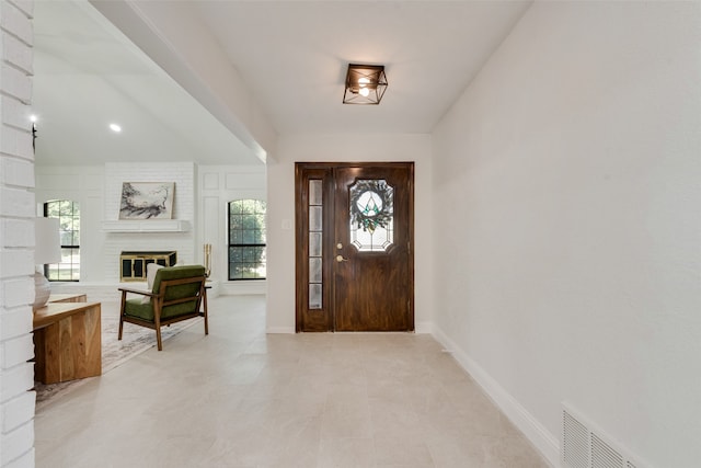 entryway with a fireplace