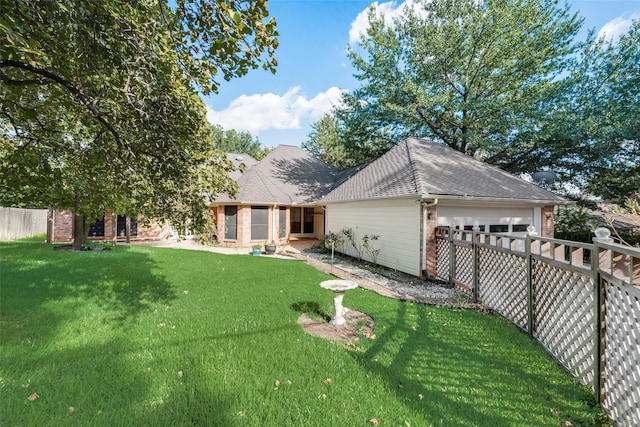 exterior space featuring a garage and a front lawn