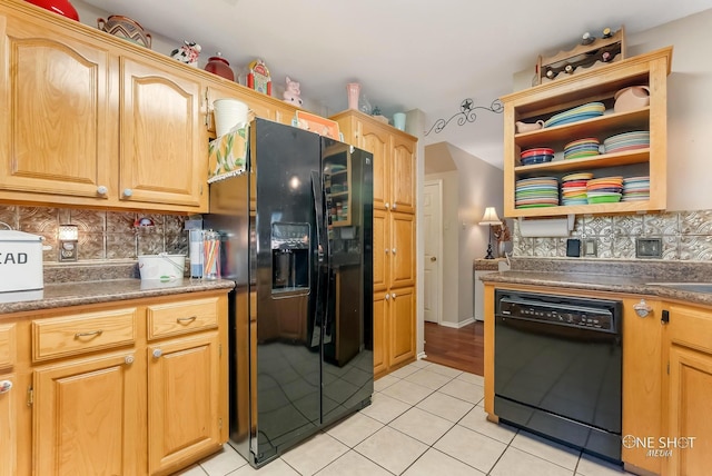 kitchen featuring light tile patterned flooring, decorative backsplash, light brown cabinetry, and black appliances