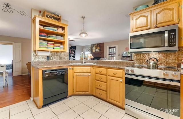 kitchen featuring sink, hanging light fixtures, backsplash, light hardwood / wood-style floors, and appliances with stainless steel finishes