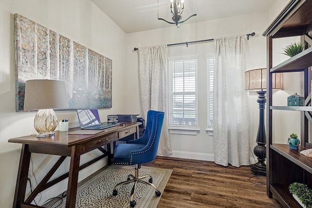 office space with dark hardwood / wood-style floors and an inviting chandelier