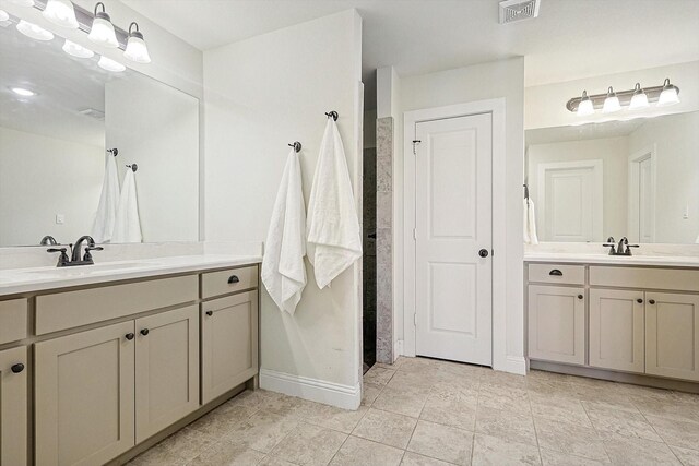 bathroom featuring tile patterned flooring and vanity