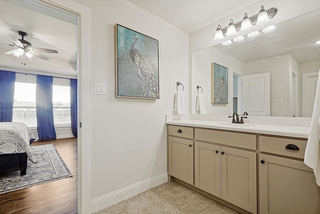 bathroom featuring ceiling fan, vanity, and wood-type flooring