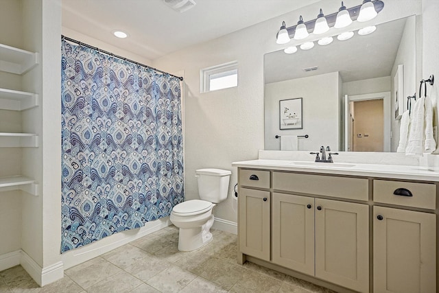 bathroom featuring tile patterned flooring, vanity, toilet, and walk in shower