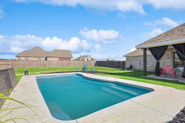 view of pool featuring a lawn and a patio