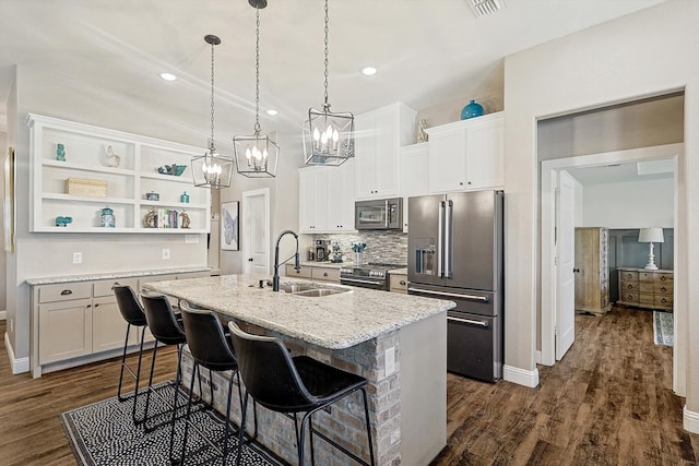 kitchen featuring sink, stainless steel appliances, dark hardwood / wood-style flooring, a center island with sink, and white cabinets