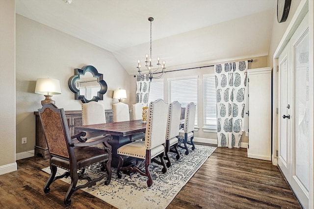 dining space featuring dark hardwood / wood-style floors, vaulted ceiling, and a notable chandelier