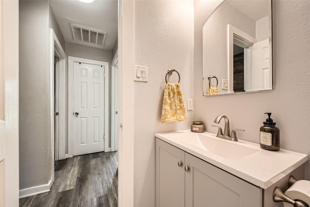 bathroom with vanity and hardwood / wood-style flooring