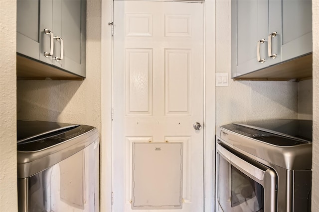 kitchen featuring separate washer and dryer and gray cabinetry