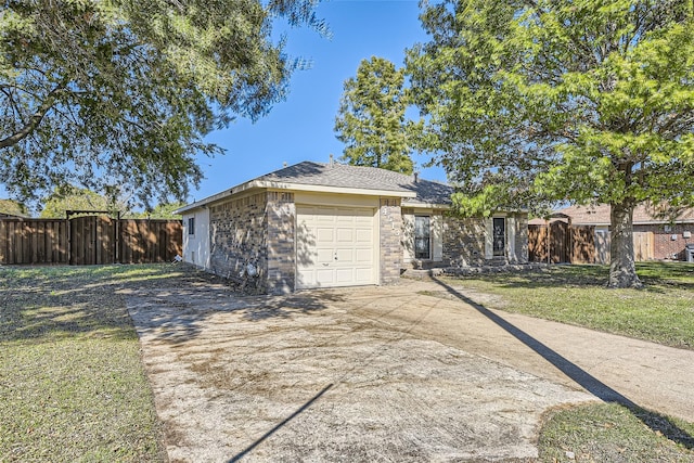 ranch-style home with a front yard and a garage