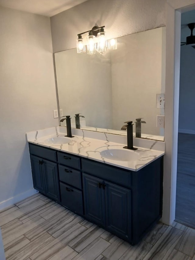 bathroom with vanity, wood-type flooring, and a notable chandelier