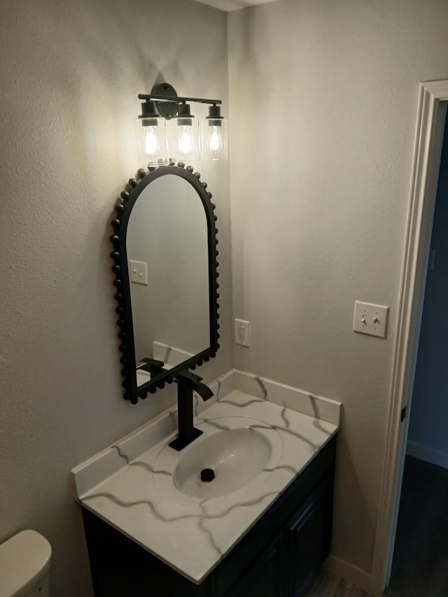 bathroom featuring vanity and toilet