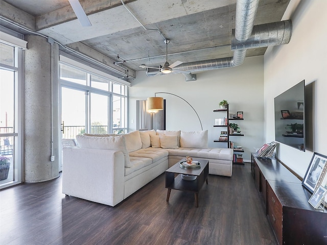 living room with dark wood-type flooring and ceiling fan