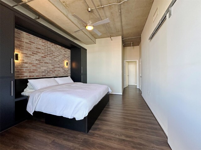 bedroom featuring brick wall and a closet