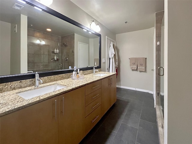 bathroom featuring a shower with door, vanity, and tile patterned floors