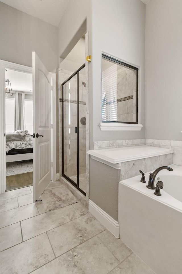 bathroom featuring separate shower and tub and a wealth of natural light