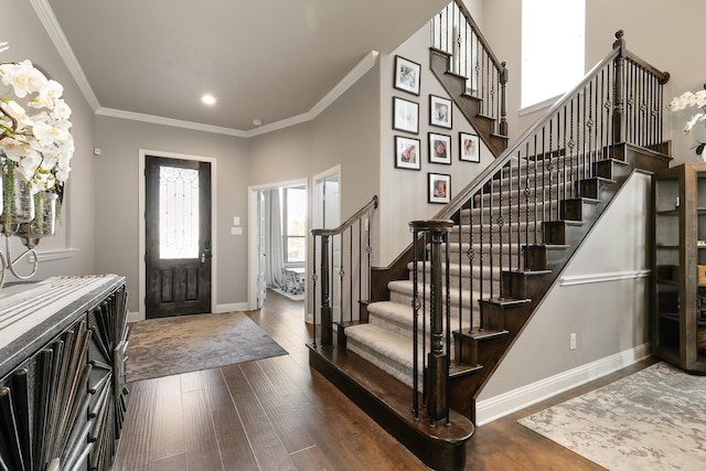 entryway with crown molding and dark hardwood / wood-style floors