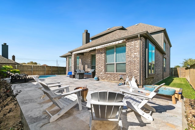 back of house with a patio area and an outdoor fire pit