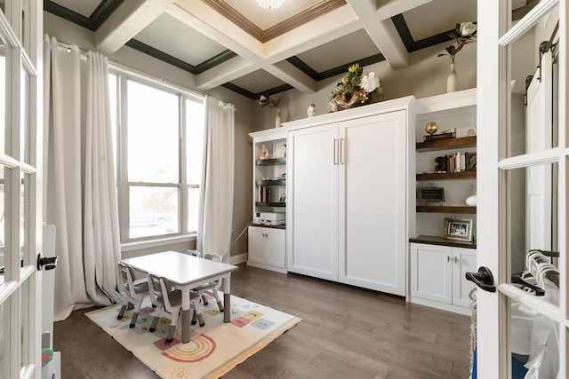 interior space with beamed ceiling, plenty of natural light, coffered ceiling, and dark hardwood / wood-style floors