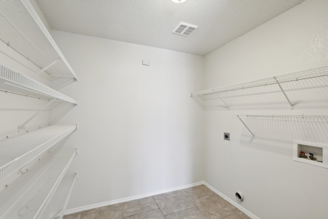 laundry area featuring washer hookup, light tile patterned floors, and electric dryer hookup