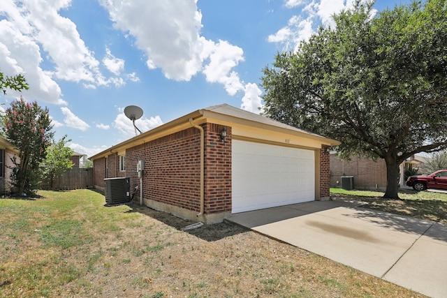 view of property exterior with a yard, a garage, and central air condition unit