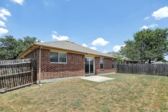 rear view of property with a patio area and a yard