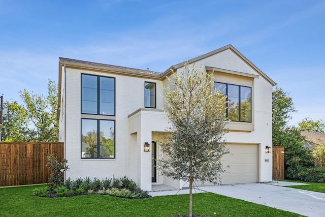 view of front facade with a front yard and a garage