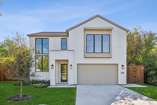 contemporary home featuring a garage and a front lawn