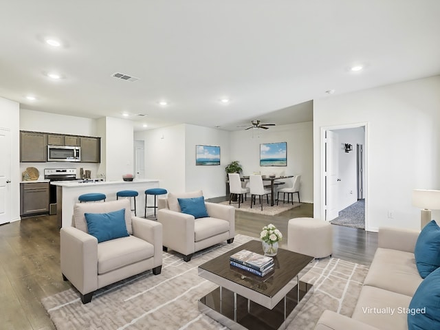 living room featuring ceiling fan and light hardwood / wood-style floors