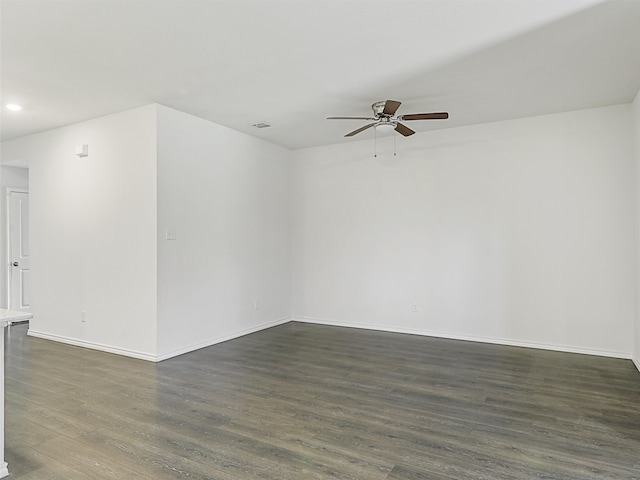 spare room featuring ceiling fan and dark hardwood / wood-style flooring