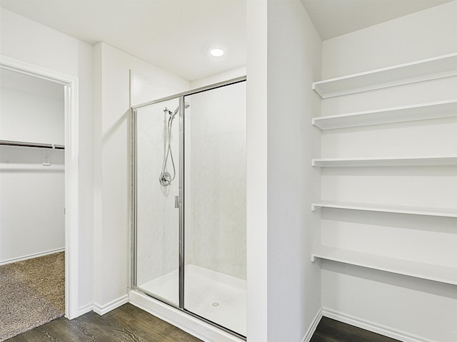 bathroom featuring a shower with shower door, toilet, wood-type flooring, and vanity