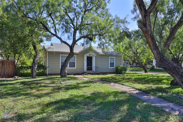 ranch-style home featuring a front yard