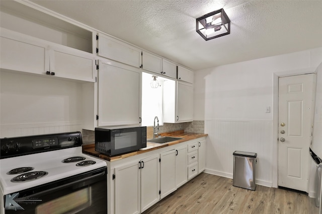 kitchen with sink, white cabinets, and black appliances