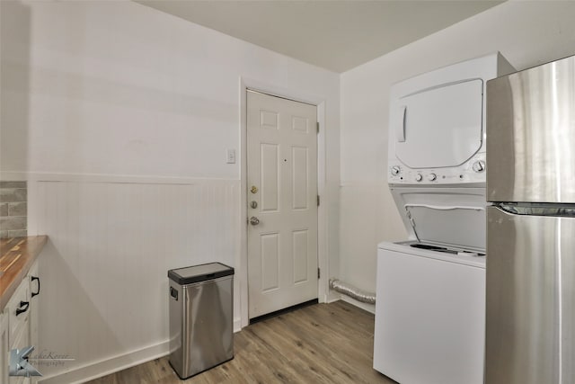 washroom featuring stacked washer / drying machine and light wood-type flooring